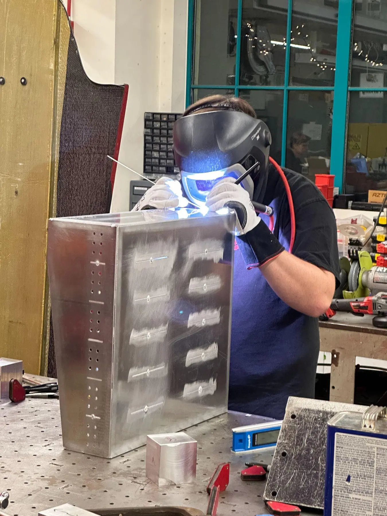 Team member welding the aluminum accumulator enclosure