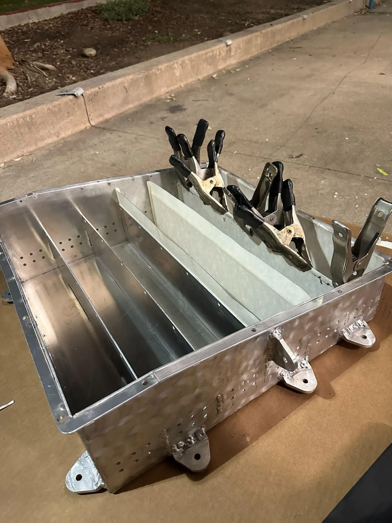 Fabricated accumulator enclosure with six open internal bays