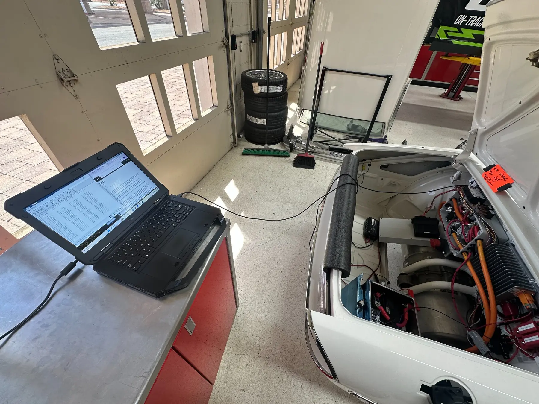 Laptop connected to the Triumph Stag during in-vehicle BMS testing