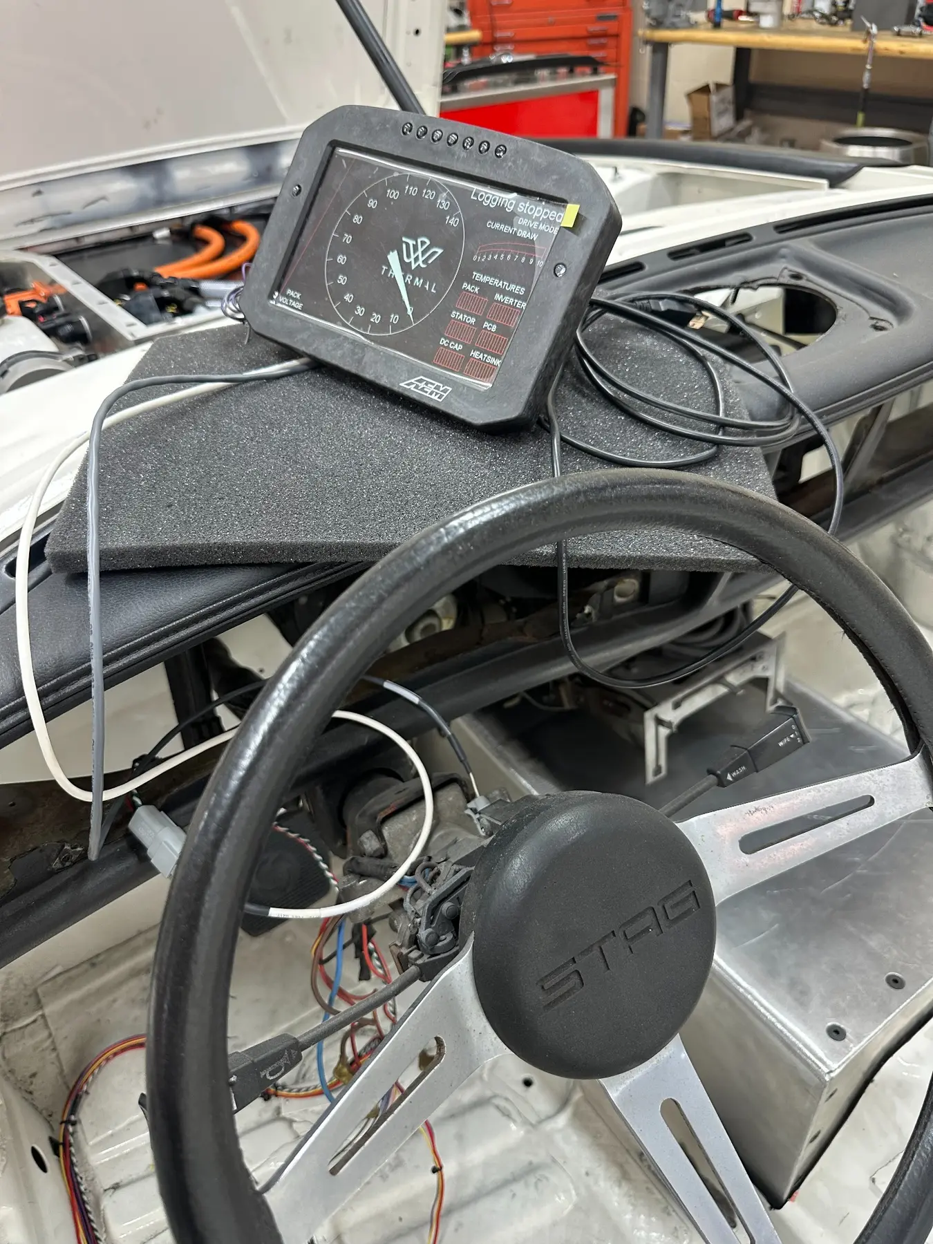 Digital dash positioned in the Triumph Stag cabin during a mockup
