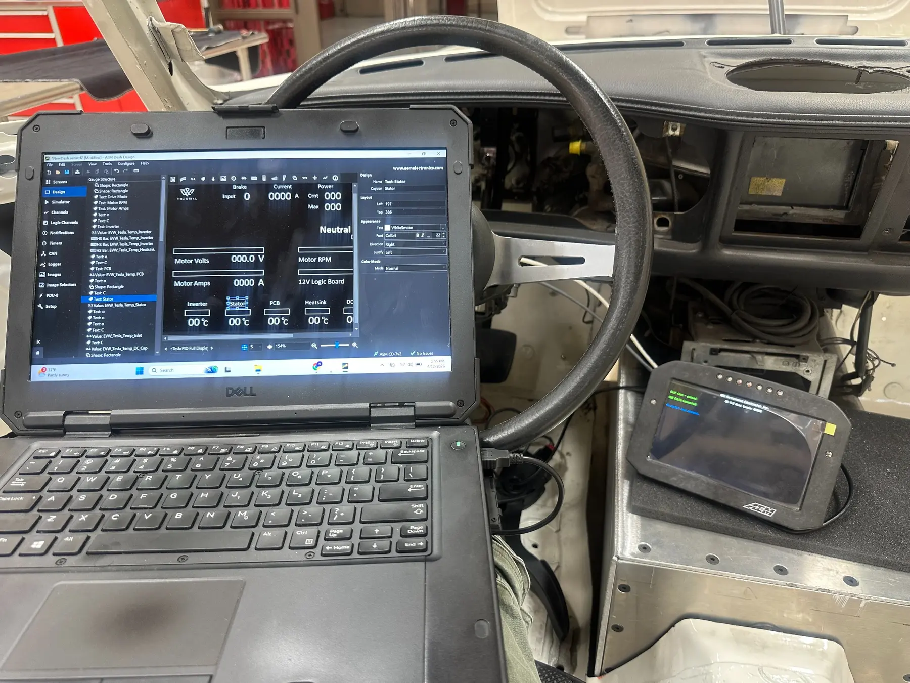 Laptop and digital dash connected inside the Triumph Stag during configuration
