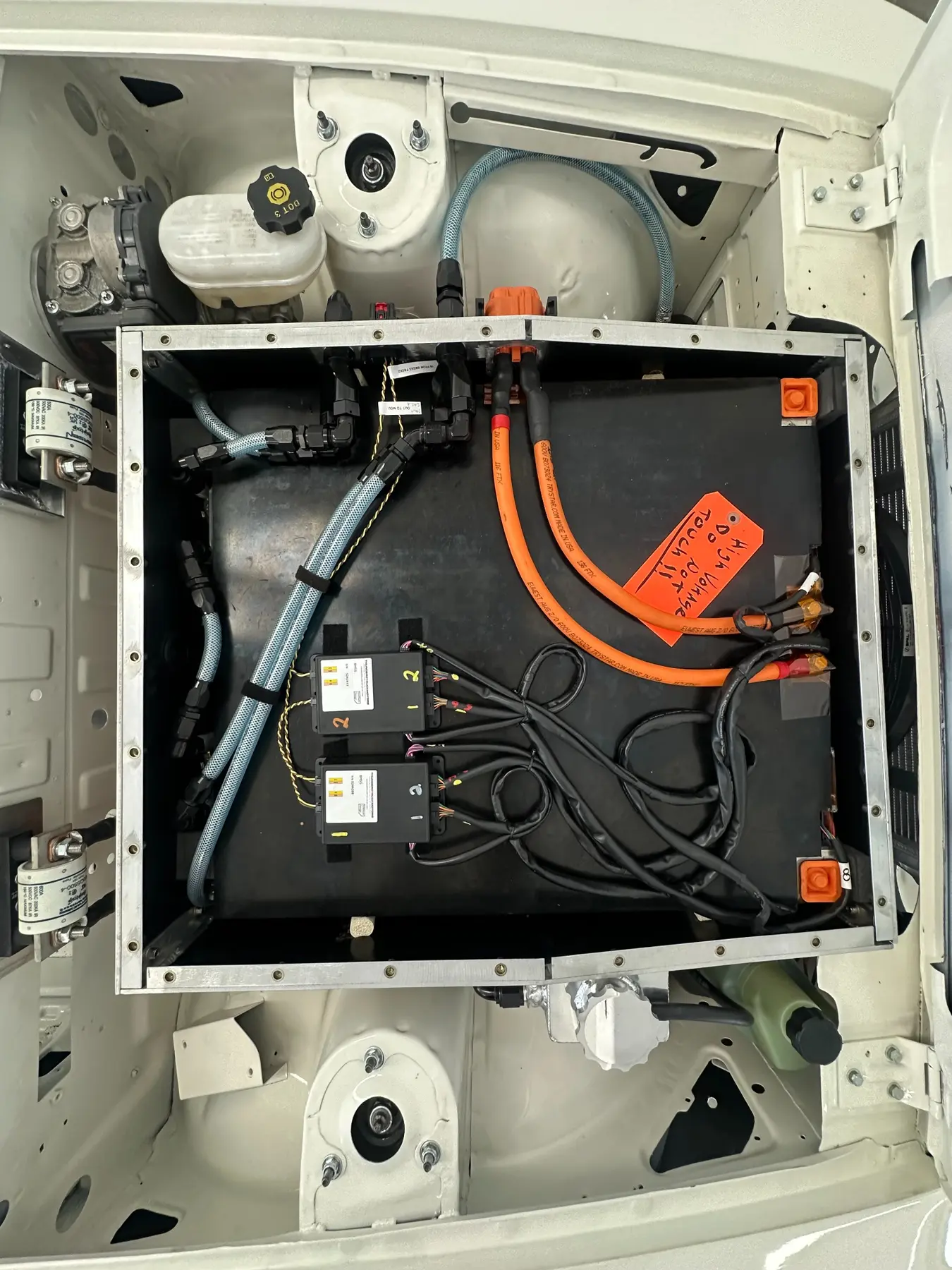 Closed front battery enclosure with high-voltage and coolant connections